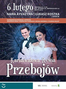 Na tle fajerwerków sylwetki artystów w strojach wieczorowych. Ciemnowłosa kobieta ma białą…