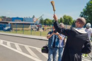 Ksiądz kropi wodą święconą nowy odcinek drogowy w Michałkowicach.