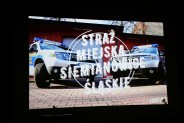 Samochody straży miejskiej na slajdzie filmu.