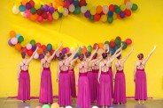 Na żółtym tle sceny amfiteatru wiszą kolorowe balony. Na scenie występuje zespół taneczny z MDK…